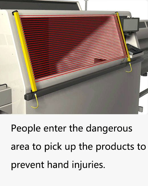 Operator retrieving a part from a press protected by a light curtain