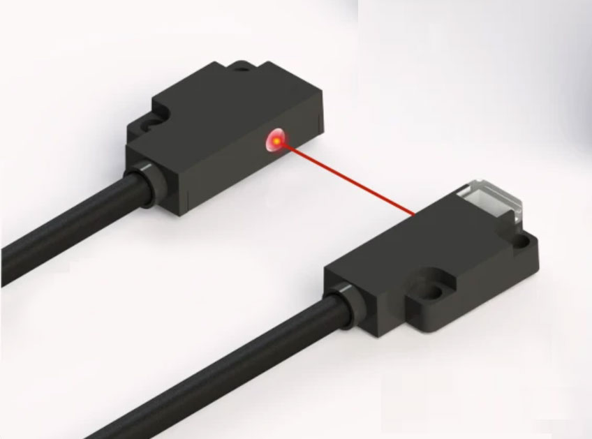 Close-up render of a DX ultra-thin through-beam pair: emitter unit projecting a red beam across a gap to the facing receiver unit